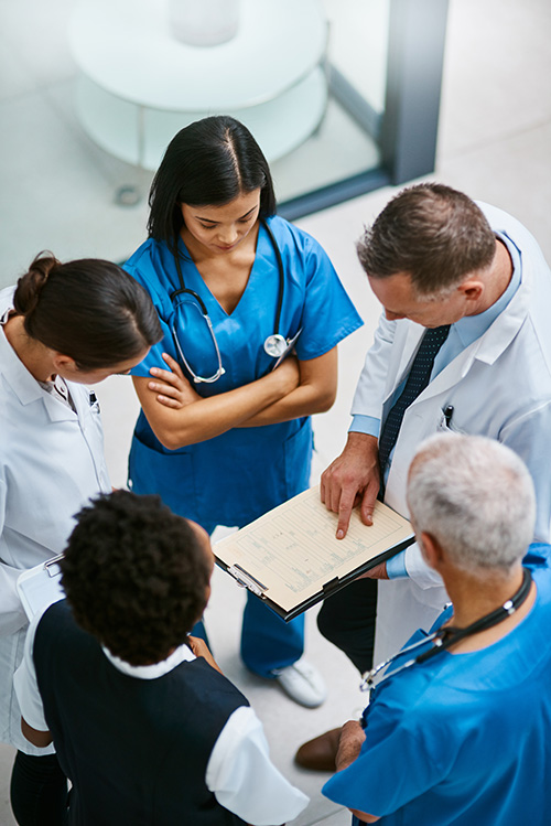 group of doctors looking at a clipboard